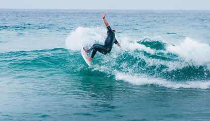 Man surfer on blue ocean wave