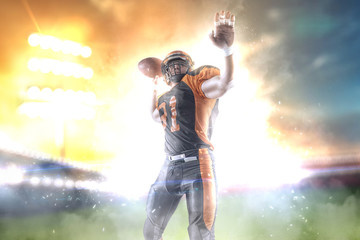Fototapeta na wymiar American football player at the stadium in black and orange outfit.