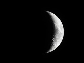 Obraz na płótnie Canvas Crescent Moon / The Moon as it appears early in its first quarter or late in its last quarter, when only a small arc-shaped section of the visible portion is illuminated by the Sun