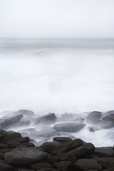 Silky water in the sea, rocks on the maritime coast, long exposure