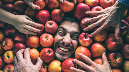 Mann mit Äpfeln , Konzept für Lebensmittelindustrie. Gesicht von lachenden mann  in Apfel Fläche.