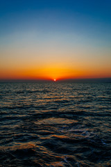 Sunset on the sea or ocean with beautiful blue sky. Sunset or sunrise scene landscape background concept image.