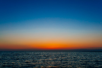 Sunset on the sea or ocean with beautiful blue sky. Sunset or sunrise scene landscape background concept image.
