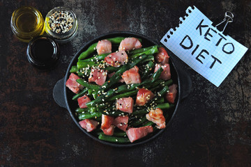 Green beans with bacon in a cast iron skillet. Healthy eating concept. Keto diet. Pegan diet. Paleo...