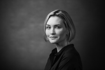 Fototapeta premium Black and white portrait of a beautiful smiling woman on a dark background