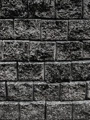 the dark grey black old brick wall.