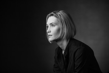 Dramatic black and white portrait of a beautiful woman on a dark background