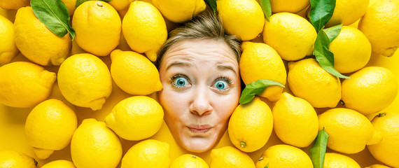 Fototapeta na wymiar Frau mit Zitronen , Konzept für Lebensmittelindustrie. Gesicht von lachende Frau in Zitronen flache.