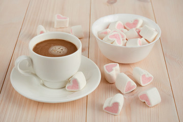 Fototapeta na wymiar Hot coffee with hearts pink marshmallow for valentine's day