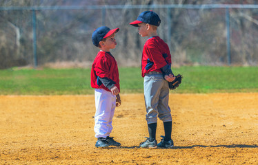 Older Boy Trying to Teach a Younger Boy How to Whistle