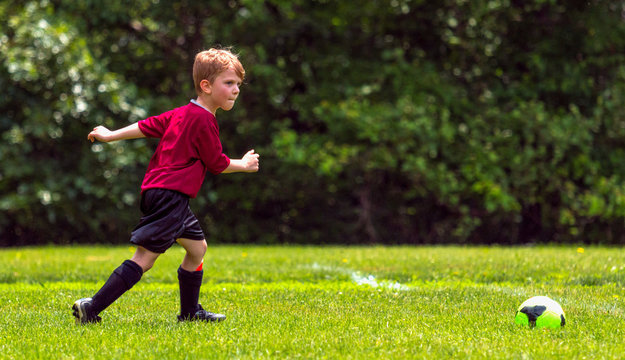 Youth Football Player Approaches Ball