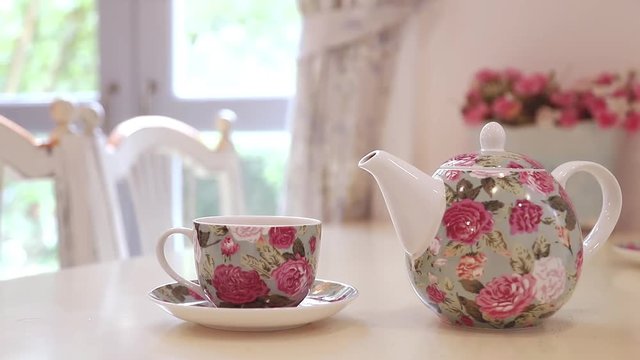 British afternoon tea set on the table with window light in background.