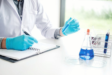 Scientist with equipment holding tools during scientific experiment science concept