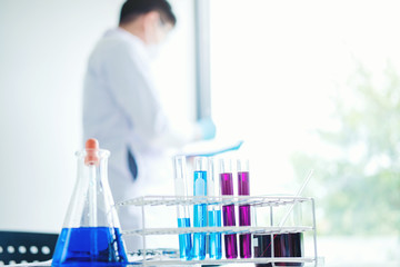 Scientist with equipment holding tools during scientific experiment science concept