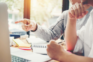High school or college students studying and reading together in library
