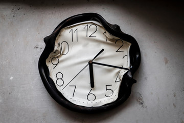 wall clock burned and melted by fire in a burnt kitchen