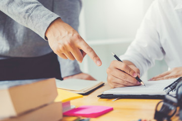 High school or college students studying and reading together in library