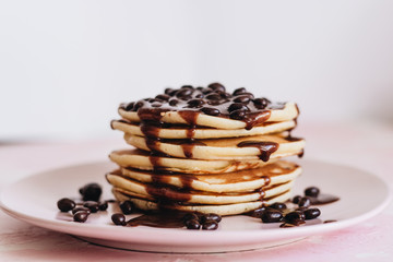 Stack of delicious homemade pancakes with sauce