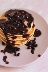 Stack of delicious homemade pancakes with sauce