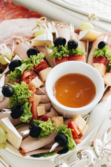 Set of skewer canapes and sauce on plate 