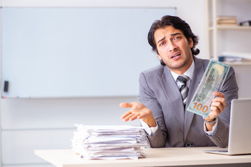 Young handsome businessman employee sitting in the office