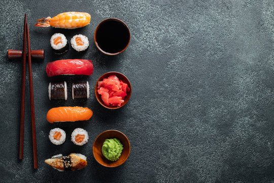 Set of sushi and maki on stone table. - Powered by Adobe