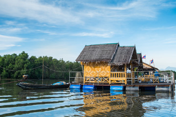 Obraz premium yellow bamboo cottage on the fish raft in the sea.