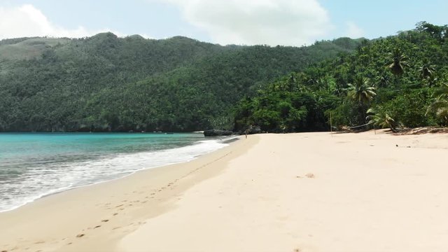 Aerial Forward: Beautiful Young Woman in Bikini Walking on Exotic Beach