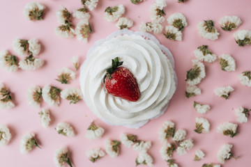 Fresh dessert with whisked cream and strawberry and flowers on table