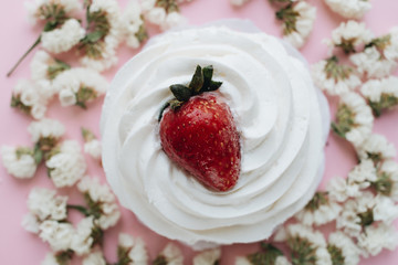 Piece of delicious fresh pastry and floral petals 