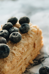 Piece of delicious cake with blueberries on marble table, sweet dessert 