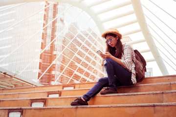 Asian women tourist Playing Smartphone To check out the attractions in Bangkok, Thailand. selfie and Upload photo to social.