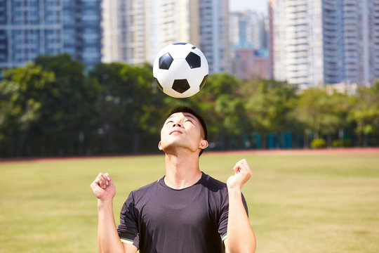 Asian Soccer Player Heading A Ball