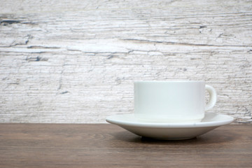 white coffee or tea cup on wooden table
