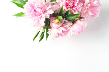 bouquet of light pink peonies on a white background. close-up view from the top, copy space