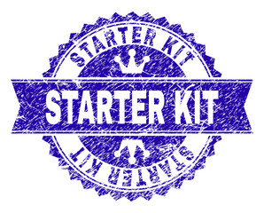 STARTER KIT rosette stamp watermark with grunge texture. Designed with round rosette, ribbon and small crowns. Blue vector rubber watermark of STARTER KIT title with dirty texture.