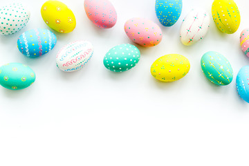 Fototapeta na wymiar Decorated Easter eggs on white background border copy space