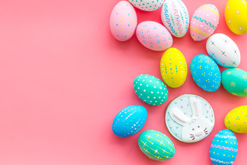 Easter symbols. Colorful Easter eggs and gingerbread on pink background space for text