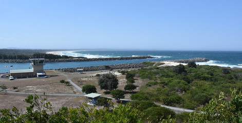 Bird view of Forster-Tuncurry beach (NSW, Australia) on a sunny day in summer time. Breakwall directing to Coolongolook river.