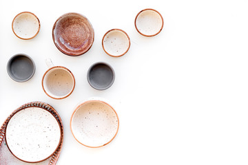 Ceramic tableware pattern. Empty plates and mugs on white background top view space for text