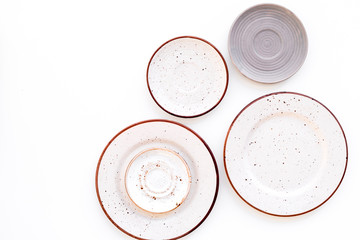 Ceramic plates pattern on white background top view copy space