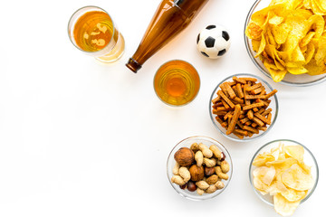 Snacks for watching football on TV. Watching sports. Chips, nuts, rusks near beer and soccer ball...
