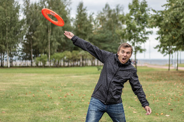 the guy is playing frisbee on the park