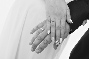 hands close-up: a man holding a woman's hand. Valentine's day: bride and groom