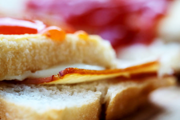 Ham cheese sandwich and tomato ketchup and chili sauce on wood tray and space for write wording, easy delicious food served with coffee or tea in coffee shop or office, popular food for office worker