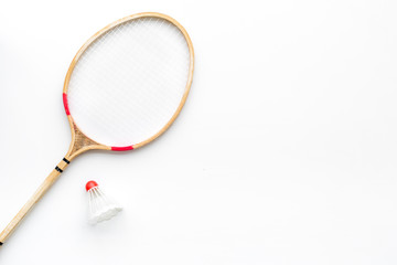 Badminton concept. Badminton rackets and shuttlecock on white background top view copy space closeup