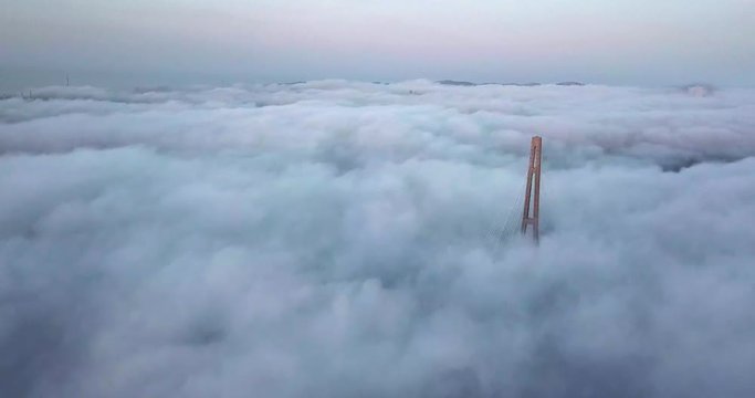 Flying above the road and between cables of cable-stayed Russian bridge across the Eastern Bosphorus strait on the way to Russian island in Vladivostok.