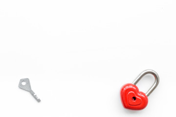 Valentine's day concept. Lock in shape of heart near key on white background top view copy space