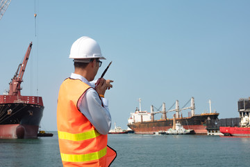 harbor master port control in command the ship to takes berthing to alongside the terminal docking,...