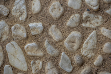 White stones embedded in grey cement image for background use with copy space